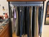 a picture of a clothing store with clothes on a rack