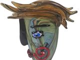 a glass sculpture of a woman ' s face on a wall