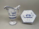 a small blue and white plate and a small blue and white pitcher