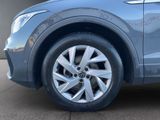 a close up of a car ' s wheel on the pavement