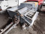 a machine that is sitting on the ground next to a truck