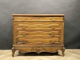 an antique chest of drawers on a chevroned wooden floor