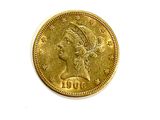 a close up of a gold coin on a white surface
