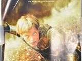 a movie poster of a young man in armor flying through the air