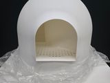 a white oven sitting on a table covered in plastic