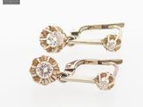 pair of yellow gold and diamond earrings on a white background