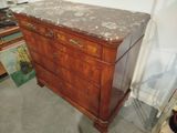 a wooden dresser with marble top in a room