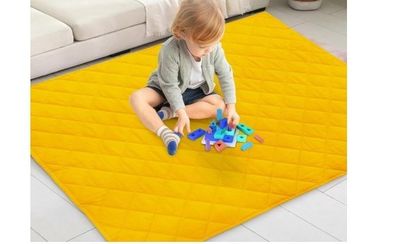 the child is playing with toys on the floor in the living room