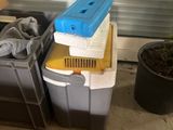 two plastic bins and a plastic planter in a garage