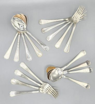 four silver spoons and two silver spoons on a table
