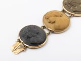 three gold and black stone cameos on a chain