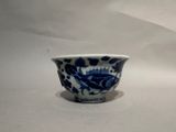 a blue and white bowl with a fish design on it