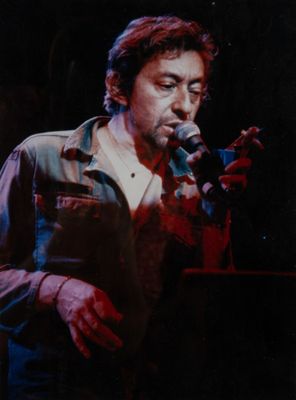 an old photo of a man holding a microphone in front of a microphone