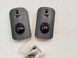 two remote controls sitting on a table next to each other