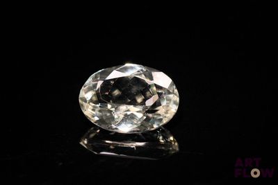 a close up of a white diamond on a black surface