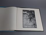 an open book with a black and white photo of a man on a horse