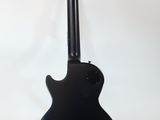 an electric guitar on a stand against a white background