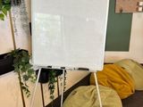 a white board on a tripod in a room