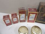 four boxes of perfumes on a table next to a box of perfumes