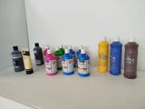 many different colors of paint on a counter top