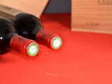 three bottles of wine sitting on a table next to a box