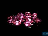 a pile of pink diamonds on a black background