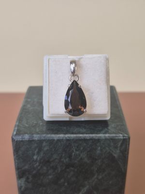 sterling silver and smokyite pendant on a marble block