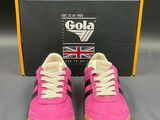 a pair of pink and black sneakers with a box in the background