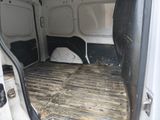a white van with a dog bed in the back of it