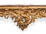 an ornately carved console table with marble top and gold leaf decoration