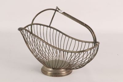 a metal basket with a handle on top of a table
