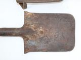 two old shovels that are sitting on a table