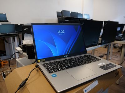 a laptop computer sitting on top of a wooden table