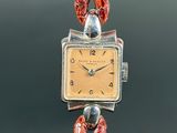 an image of a woman ' s wrist watch with a bird on it