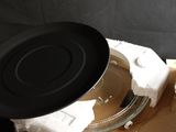 a black pan sitting on top of a cardboard box on a table