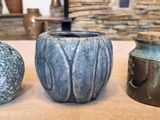 three vases sitting on a table next to each other