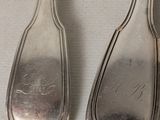 two spoons that are sitting next to each other on a table