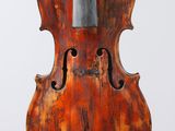 an old violin on a stand against a white background