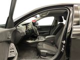 the interior of a car with the door open and the driver ' s seat down
