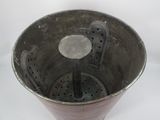 a metal bowl with holes in it on a white surface