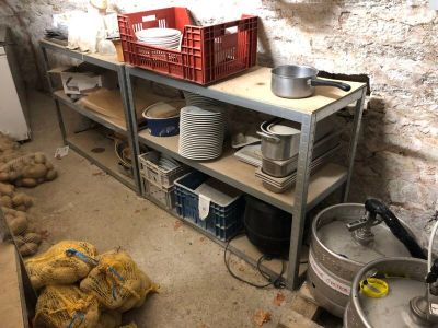 a shelf with pots and pans on it in a kitchen