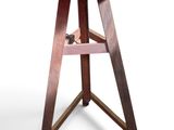 a small wooden table with a wine bottle on it