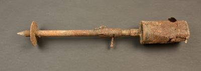 an old rusted metal pipe on a gray surface