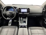 the interior of a car with a steering wheel, dashboard, and dashboard controls