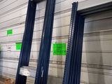 three blue metal shelves with signs on them in a store