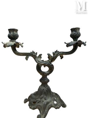 a candle holder that has two birds on it