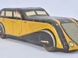 yellow and black toy car sitting on top of a white surface