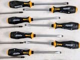a lot of screwdrivers that are lined up on a table