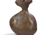 sculpture of a pomegranate on a white surface with a shadow