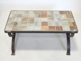 a coffee table that has a tile top on it